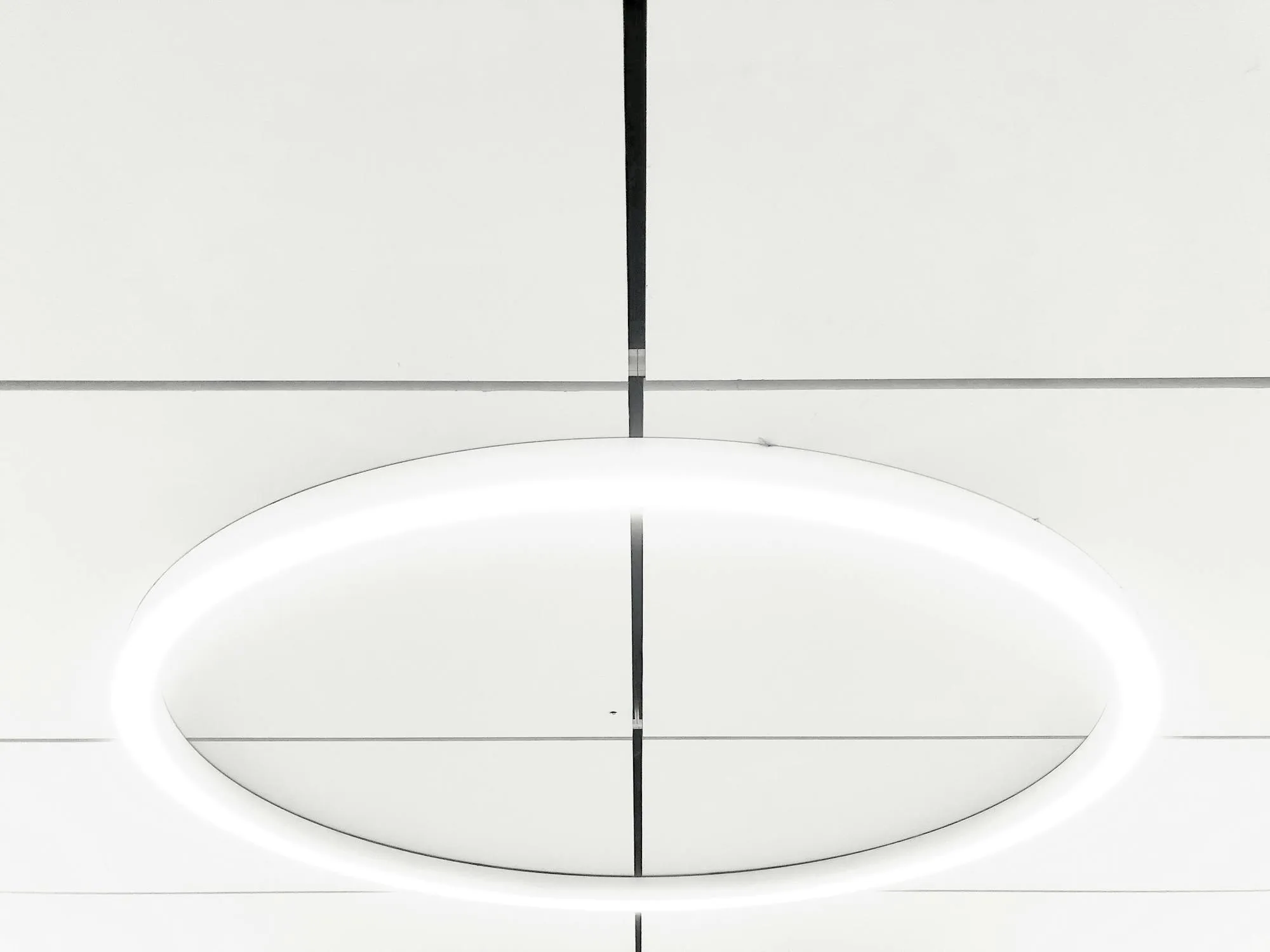 Circular LED pendant in a modern interior ceiling